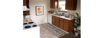 A kitchen with a stove top oven and a sink.