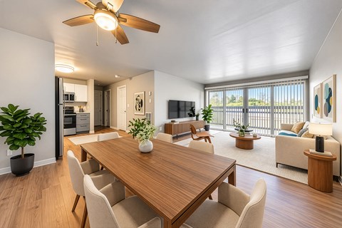 A modern dining room with a wooden table and chairs.