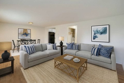 A living room with a grey couch and a coffee table.