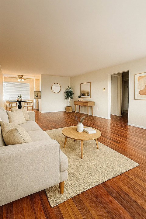 A living room with a couch, a table, and a rug.