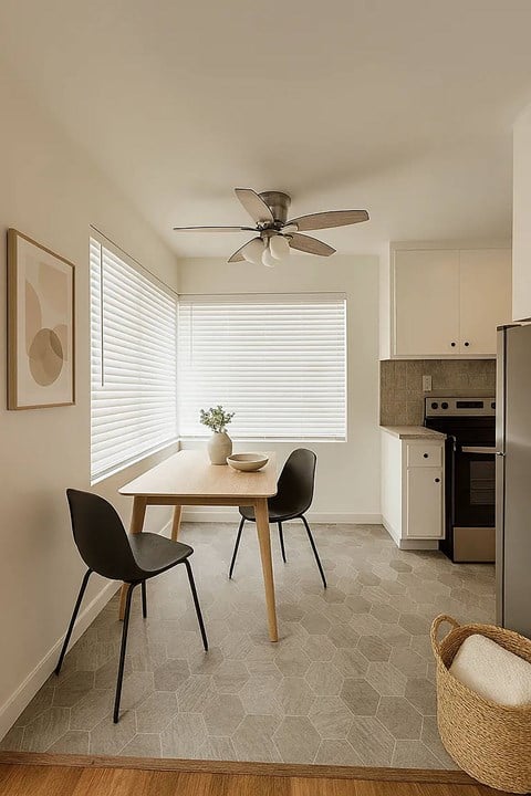 A small dining room with a table and chairs.