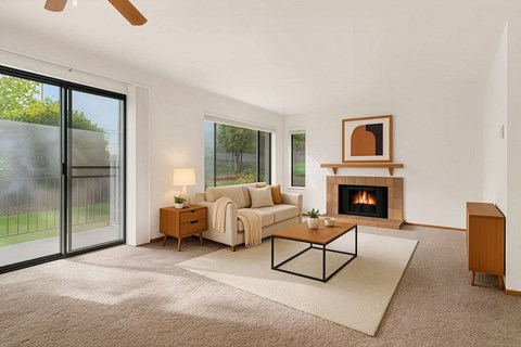 A living room with a fireplace and sliding glass doors.