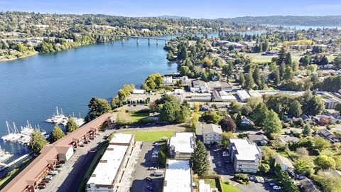 A large body of water with a bridge in the background and a building in the foreground.