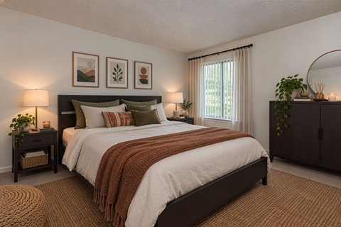 A bedroom with a large bed and a window with curtains.