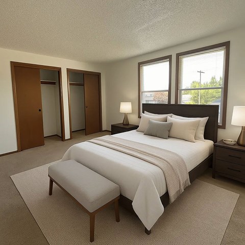 A bedroom with a large bed and a bench in front of it.