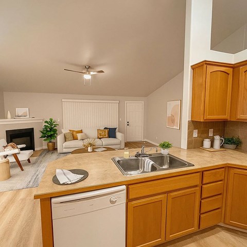 A kitchen with wooden cabinets and a white dishwasher.