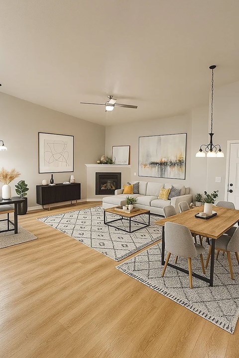 A modern living room with a fireplace and a dining table set up.