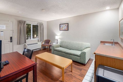 A living room with a couch, chair, and coffee table.