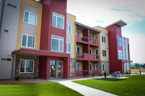 Apartment building with a red and beige exterior.