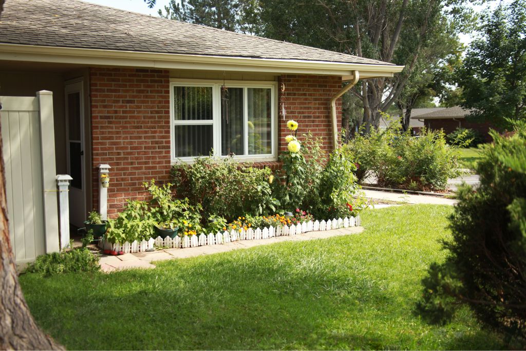 A house with a white picket fence in front of it.