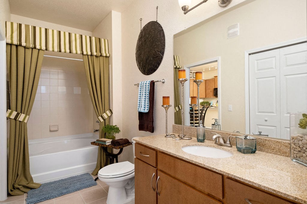 a bathroom with a sink toilet and a bath tub