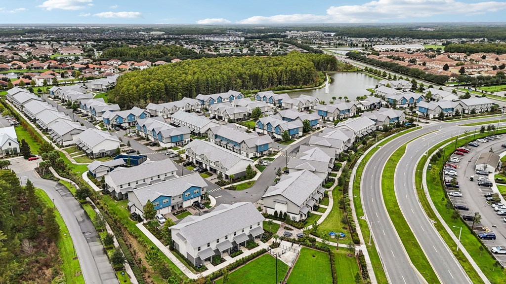 A bird's eye view of a residential area with houses and a river.