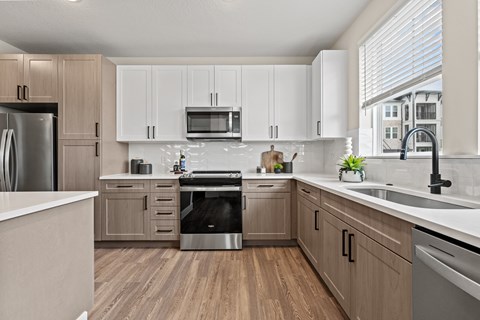 A kitchen with wooden cabinets and stainless steel appliances.