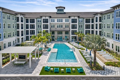 A large building with a pool in front.