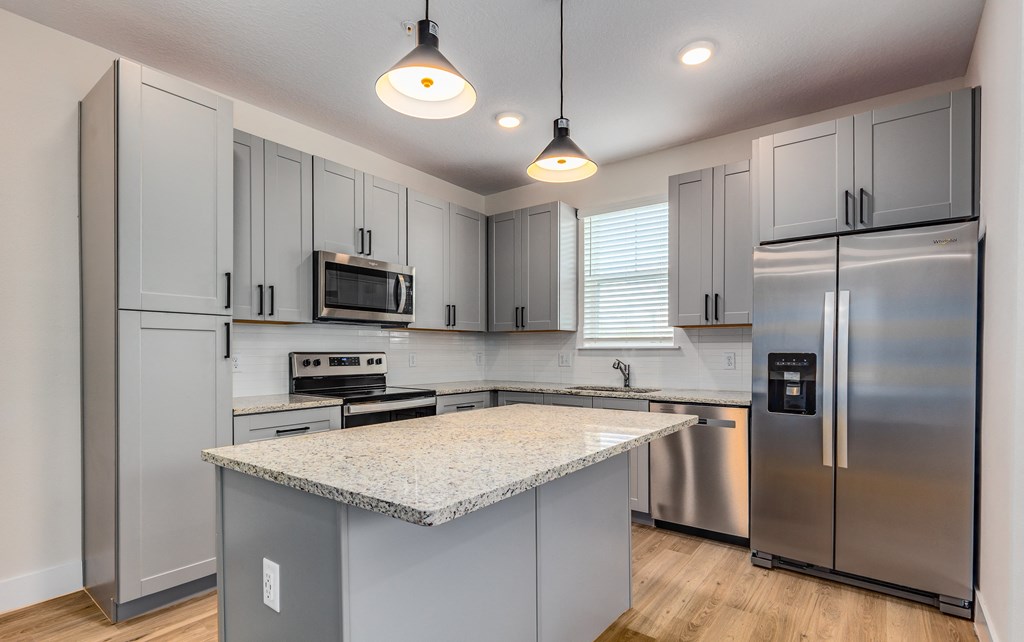 a kitchen with stainless steel appliances and a granite counter top