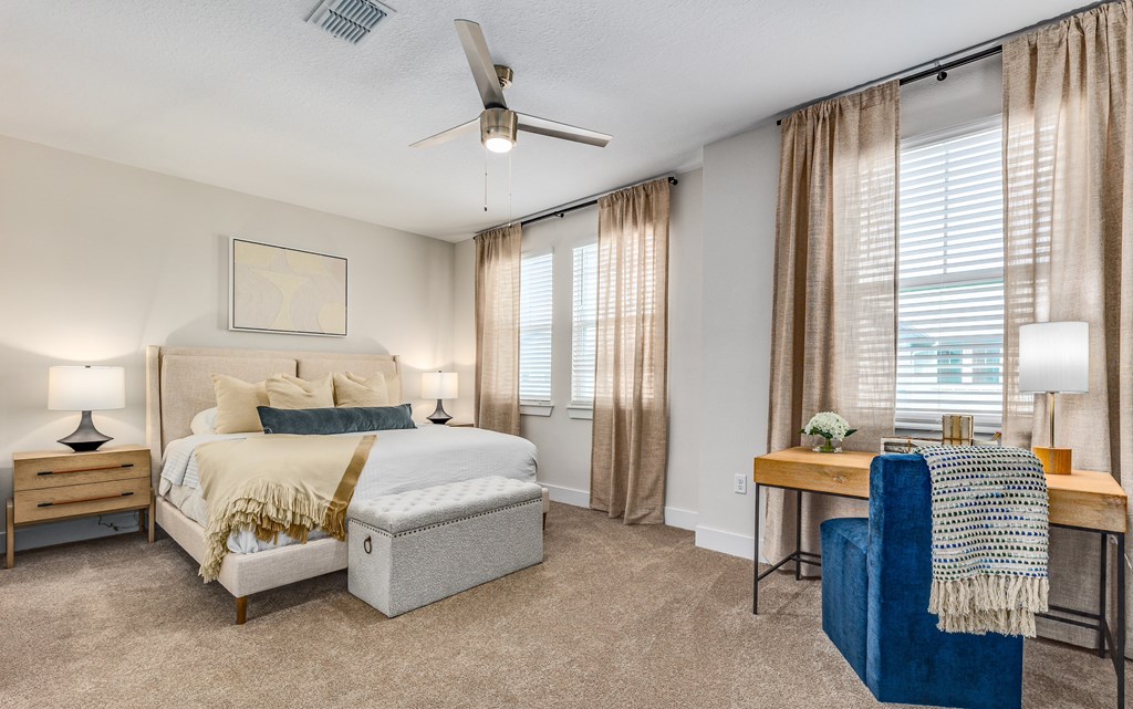 a bedroom with a large bed and a chair