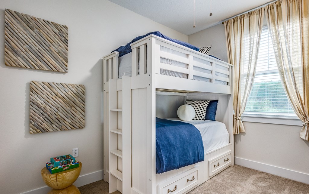 two bunk beds in a room with a window