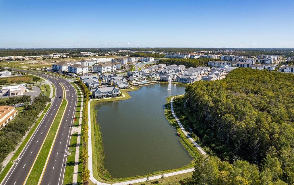 an aerial view of a city with a river and highways