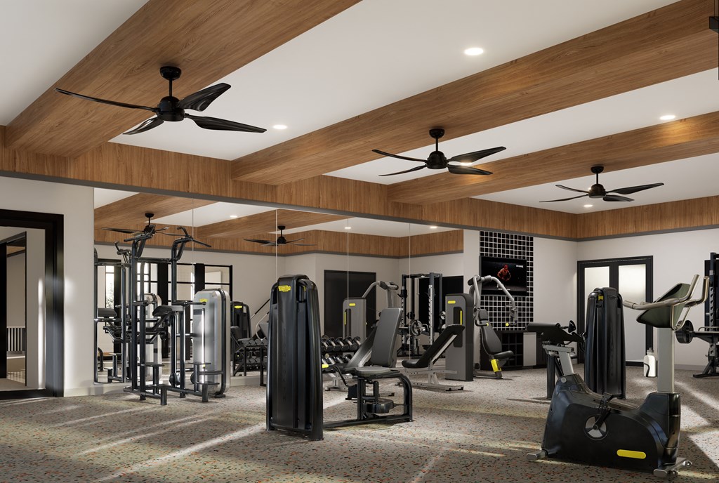 a gym with cardio equipment and ceiling fans