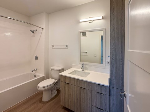 A white toilet sits next to a sink in a bathroom.