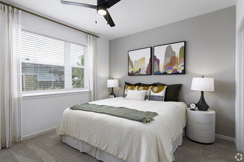 a bedroom with a large bed and a window
