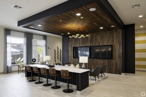 a conference room with a long table and chairs and a tv