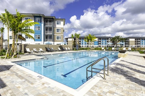 a large swimming pool with a building in the background