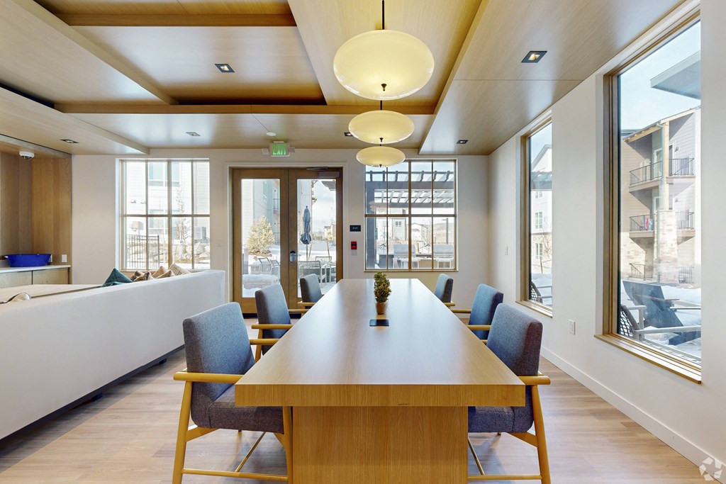 A conference room with a long table and chairs.