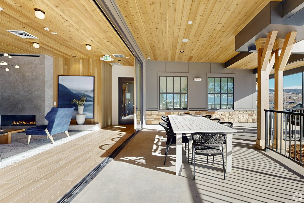 A modern dining area with a wooden table and chairs.