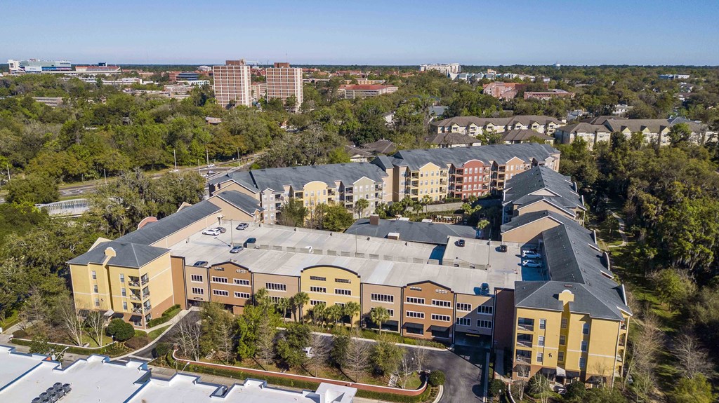 an aerial view of a building with a city in the background