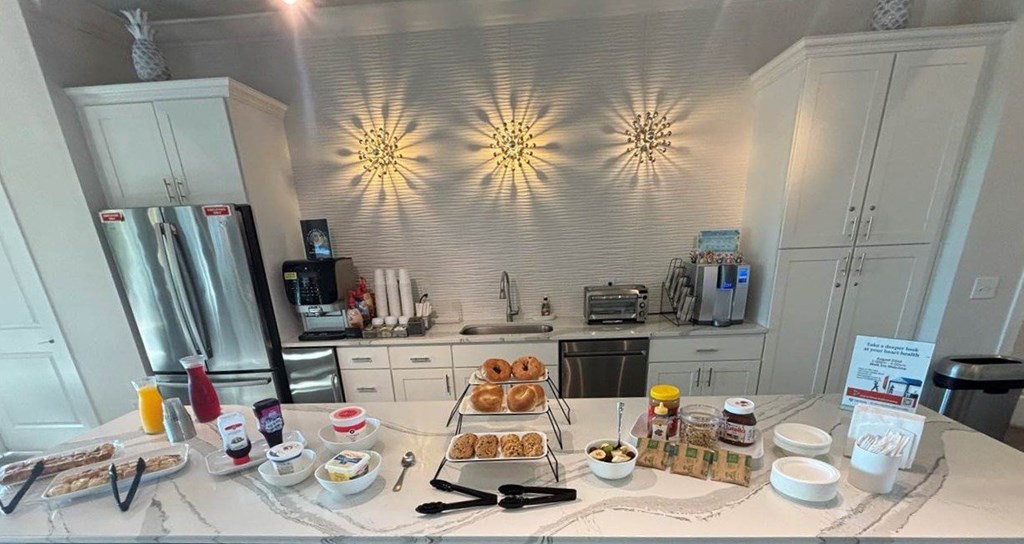 A breakfast spread is laid out on a table in a kitchen.