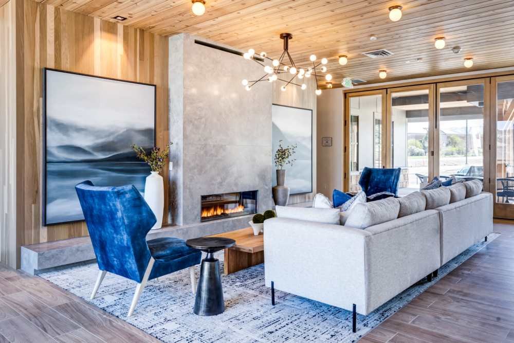 a living room with a couch and chairs and a fireplace