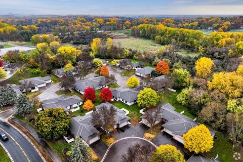 A suburban neighborhood with houses and trees in autumn colors.