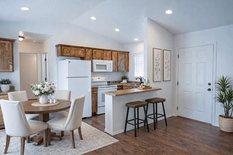 A kitchen with a table and chairs in the middle of the room.