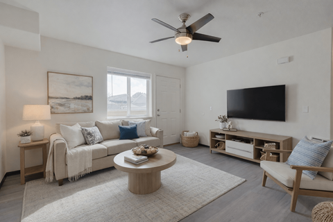 A living room with a couch, a coffee table, and a television.