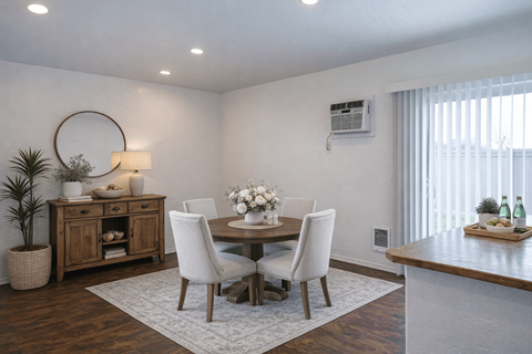 A dining room with a white table and chairs.
