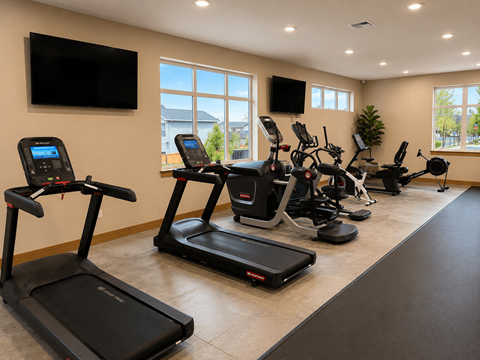 A gym with treadmills and elliptical machines.