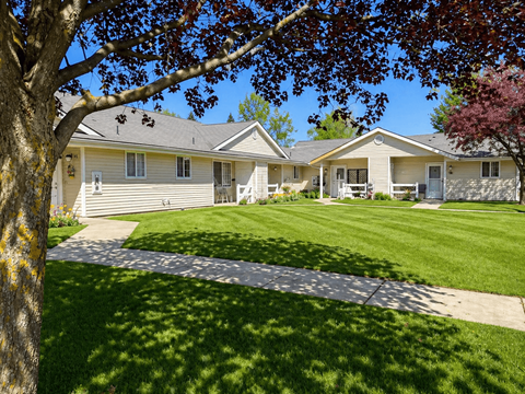 A tree is in front of a house.