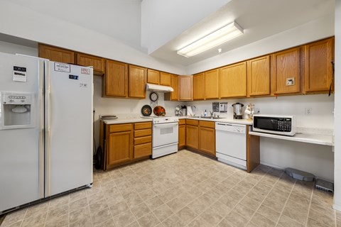 A kitchen with wooden cabinets and a white refrigerator.