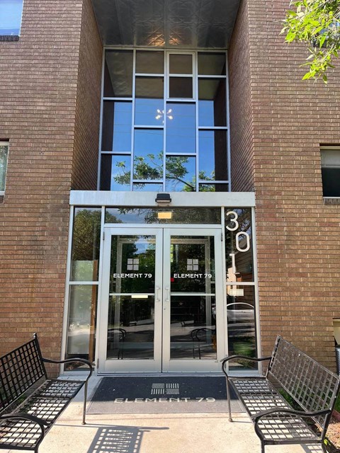 The front of a building with a glass door and windows.