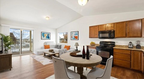 A modern kitchen with wooden cabinets and a dining table with chairs.