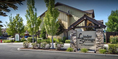 A building with a sign that says Linder Springs at Paramount.