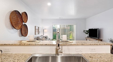 A kitchen with a sink and a window.