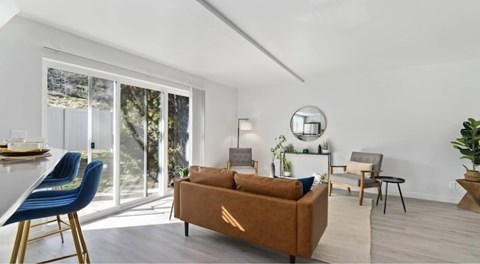 A living room with a brown couch and blue chairs.