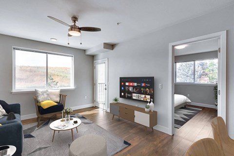 A living room with a television and a chair.