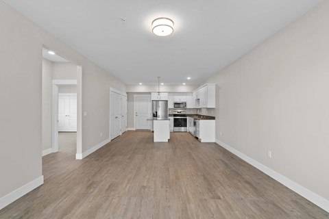 A spacious kitchen with white cabinets and a central island.