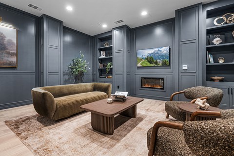 A living room with a fireplace and a painting on the wall.