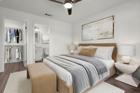 A bedroom with a bed, a chair, and a painting on the wall.