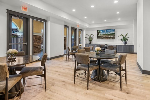 A dining room with a table and chairs.