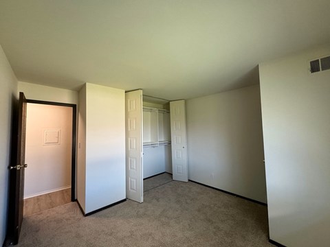 A room with a carpeted floor and white walls.
